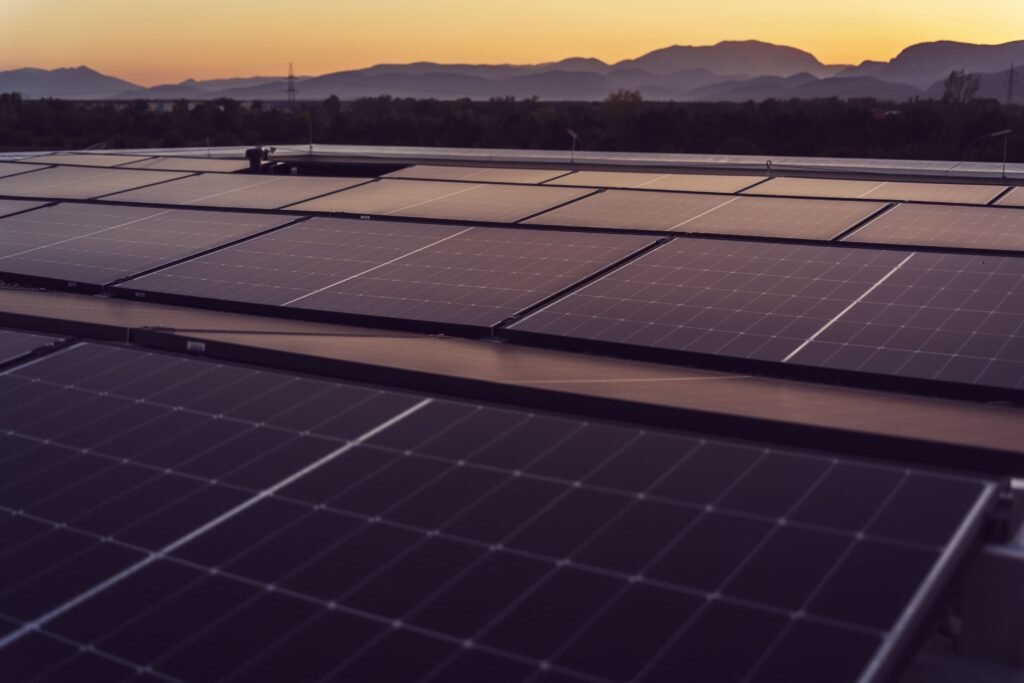 Solar panels beneath a glowing sunset sky